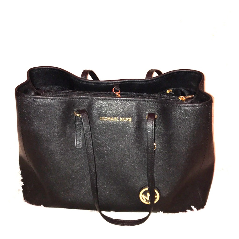Michael Kor’s book bag with gold emblems